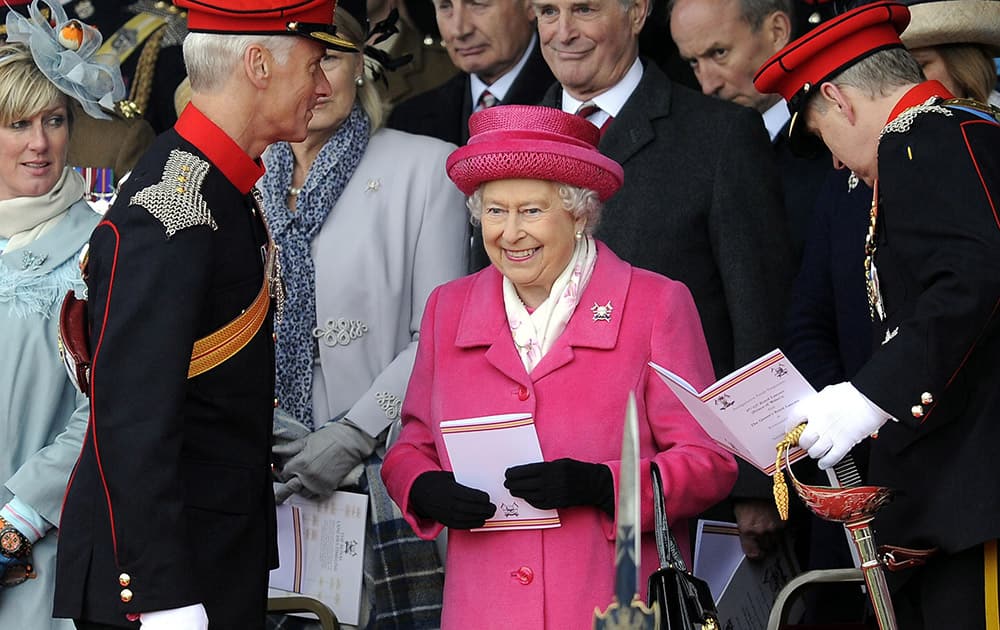 Britain's Queen Elizabeth II smiles during a visit to Richmond Castle to attend the amalgamation parade of The Queen's Royal Lancers and 9th/12th Royal Lancers, in Richmond, England. Earlier Saturday, Kate, The Duchess of Cambridge gave birth to a baby girl, that will now be fourth in line to the throne. 