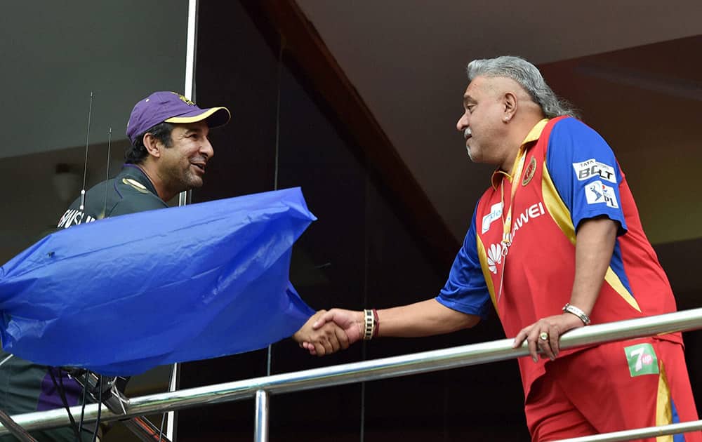 RCB owner Vijay Mallya and KKR Bowling coach Wasim Akram during the IPL match in Bengaluru.