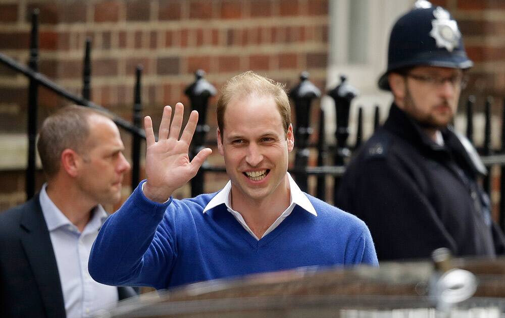 Britain's Prince William waves and smiles as he leaves St. Mary's Hospital's exclusive Lindo Wing, London. William's wife, Kate, the Duchess of Cambridge, gave birth to a baby girl on Saturday morning.