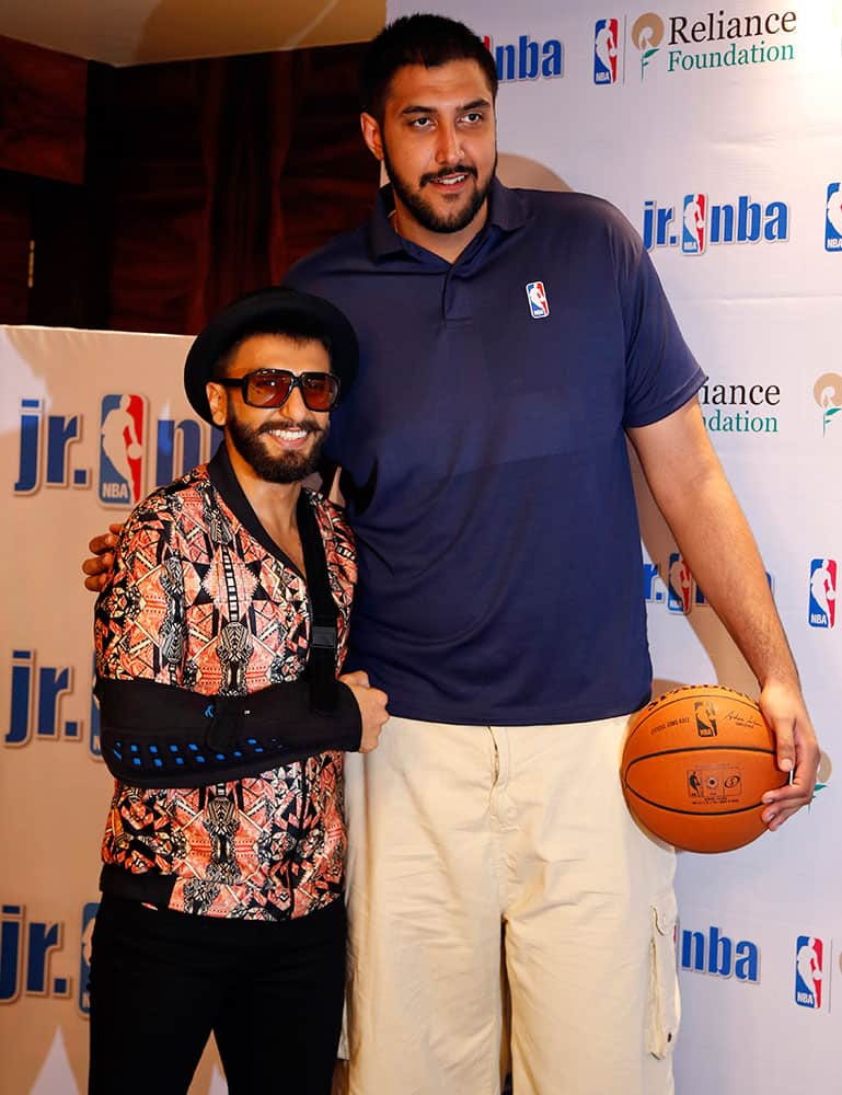 NBA’s first player of Indian descent Sim Bhullar poses for photographers with Bollywood actor Ranveer Singh during a press conference in Mumbai, India.