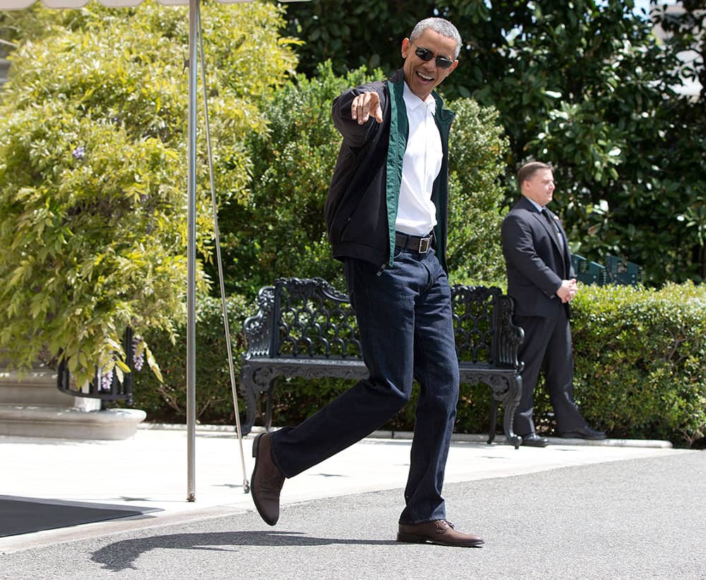 President Barack Obama looks to Luca Martinez, 4, as he walks from the White House to board Marine One, in Washington, en route to the presidential retreat at Camp David, Md. 