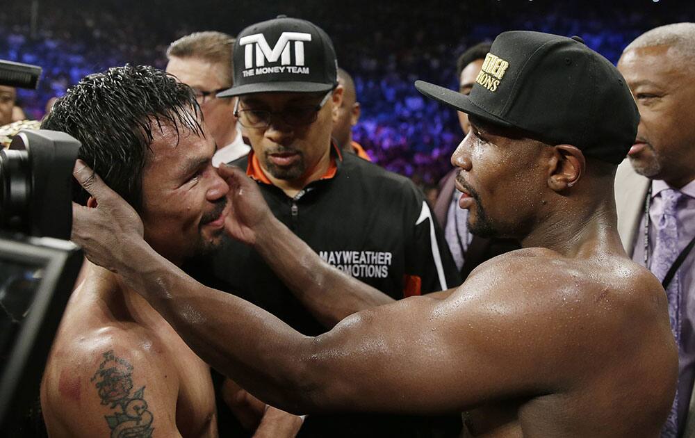 Manny Pacquiao, from the Philippines, left, and Floyd Mayweather Jr., embrace in the ring at the finish of their welterweight title fight in Las Vegas.