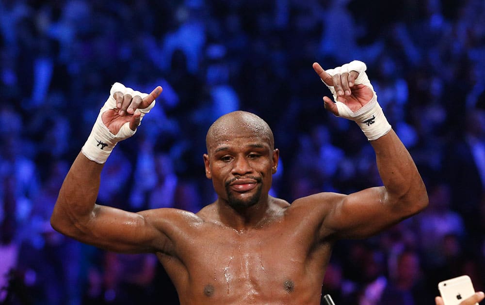 Floyd Mayweather Jr., celebrates his unanimous decision victory over Manny Pacquiao, from the Philippines, at the finish of their welterweight title fight in Las Vegas. 