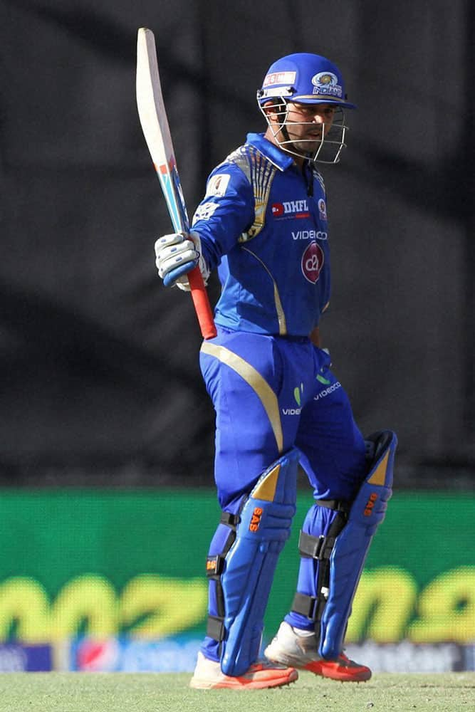 Parthiv Patel of the Mumbai Indians raises his bat after scoring 50 runs during IPL match against The Mumbai Indians in Mohali.