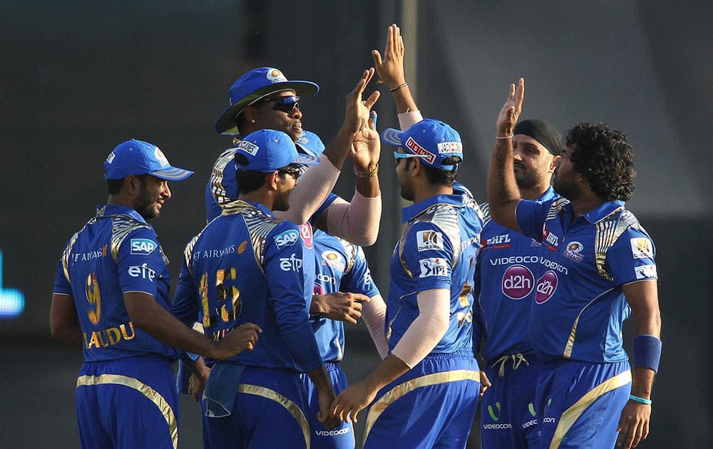 Kieron Pollard of Mumbai Indians and Lasith Malinga of Mumbai Indians are congratulated for getting Virender Sehwag of Kings XI Punjab wicket during IPL match in Mohali.