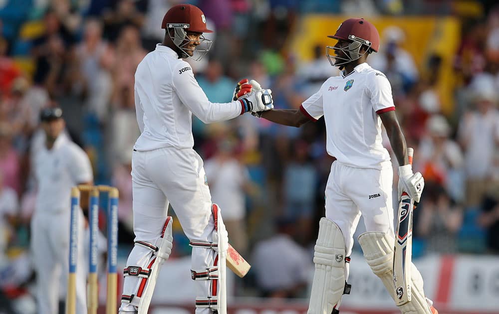 West Indies' captain Denesh Ramdin, left, and teammate Jermaine Blackwood celebrate defeating England by five wickets during day three of their third Test match at the Kensington Oval in Bridgetown, Barbados.