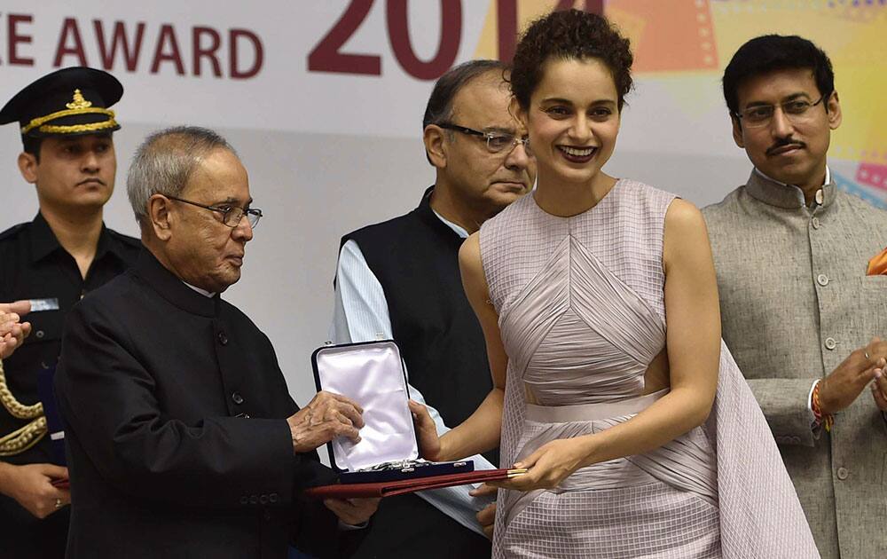 President Pranab Mukherjee presents the national award for the Best actress to Bollywood actor Kangana Ranaut in New Delhi, India.