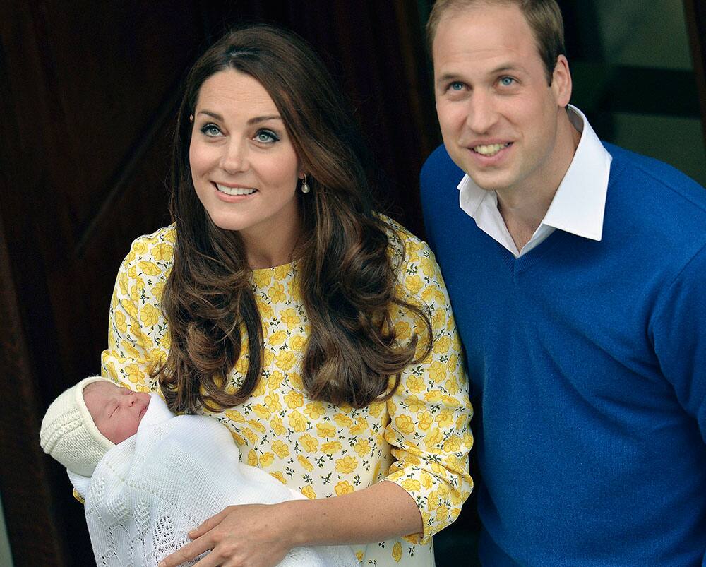 Britain's Prince William stands close to Kate, Duchess of Cambridge as she carries their newborn baby princess as they leave St. Mary's Hospital's exclusive Lindo Wing, London.