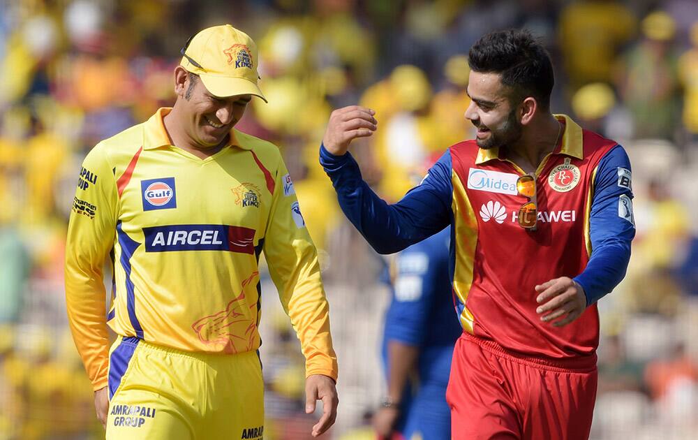 Chennai Super Kings’ Skipper MS Dhoni and Royal Challengers Bangalore Skipper Virat Kohli during the IPL match at MAC Stadium in Chennai.
