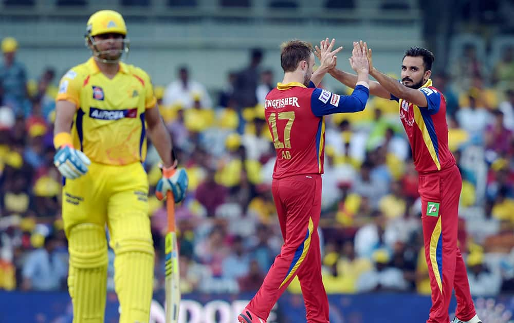 Royal Challengers Bangalore player Harshal Patel celebrating along with a teammate the wicket of Chennai Super Kings Suresh Raina during their IPL-2015 match at MAC Stadium in Chennai.