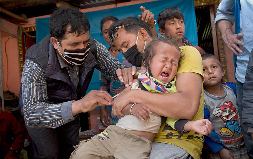 A Nepalese infant is given a vaccination in Lapsiphedi, near Kathmandu, Nepal.