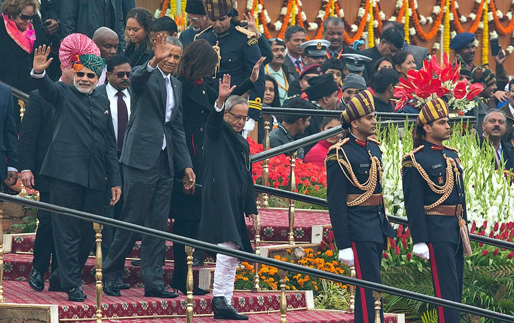 US President Barack Obama, Prime Minister Narendra Modi and President Pranab Mukherjee wave to the crowd at the end of India’s annual Republic Day parade in New Delhi.