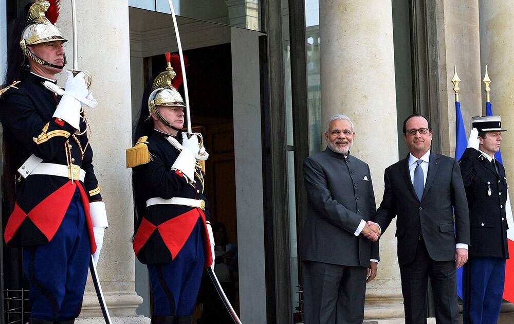 Prime Minister Narendra Modi and French President Francois Hollande shake hands before a meeting in Paris.