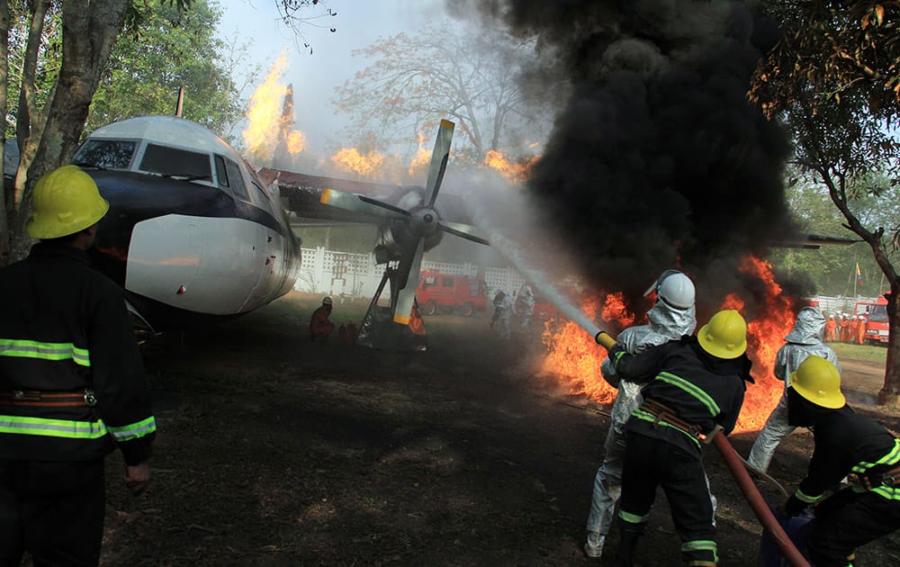 Members of Myanmar Fire Brigade put out the fire of a burning airplane during their demonstration at a ceremony to mark the 69th anniversary Myanmar Fire Brigade Day in Yangon, Myanmar.