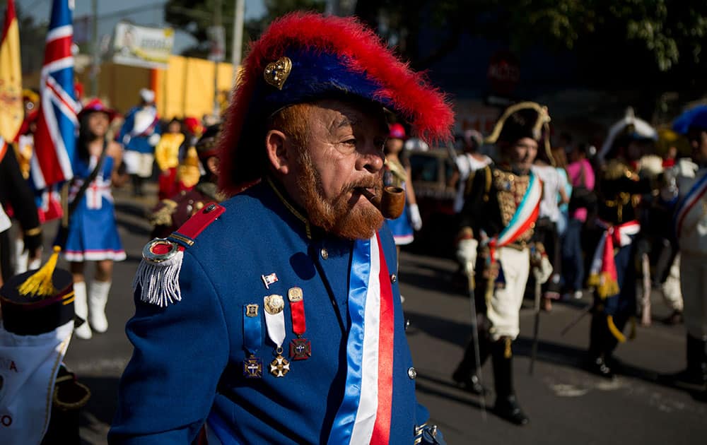 Mexicans dressed as French Army officers walk in a parade ahead of a reenactment of the battle of Puebla between Zacapoaxtla Indians and the French army during Cinco de Mayo celebrations in the Penon de los Banos neighborhood of Mexico City.