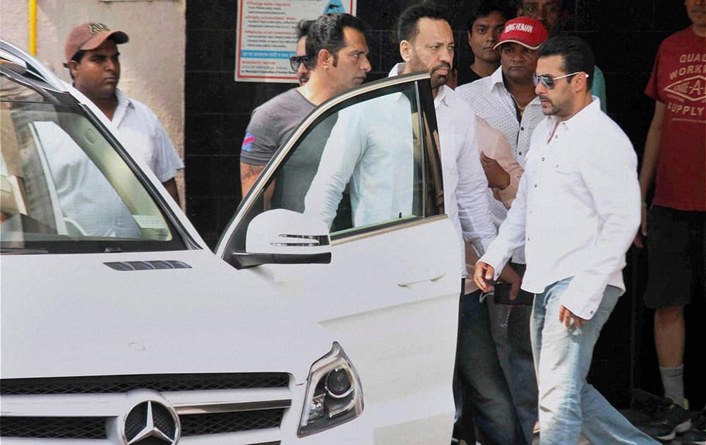 Salman Khan walks towards a car to head for court in Mumbai.