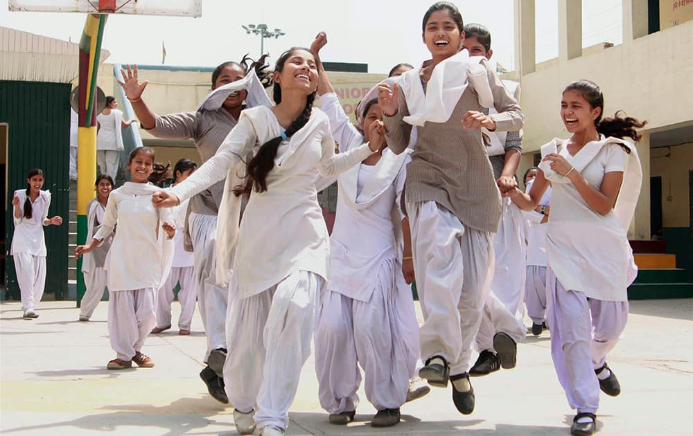 Students celebrate their success after announcement of Haryana Board class 10th and 12th results, in Gurgaon.