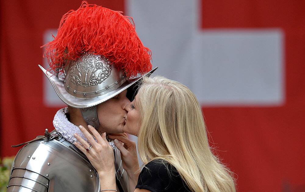 Dominic Bergamin, left, a new Vatican Swiss Guard, is is kissed by his wife Joanne, prior to a swearing-in ceremony, at the Vatican.