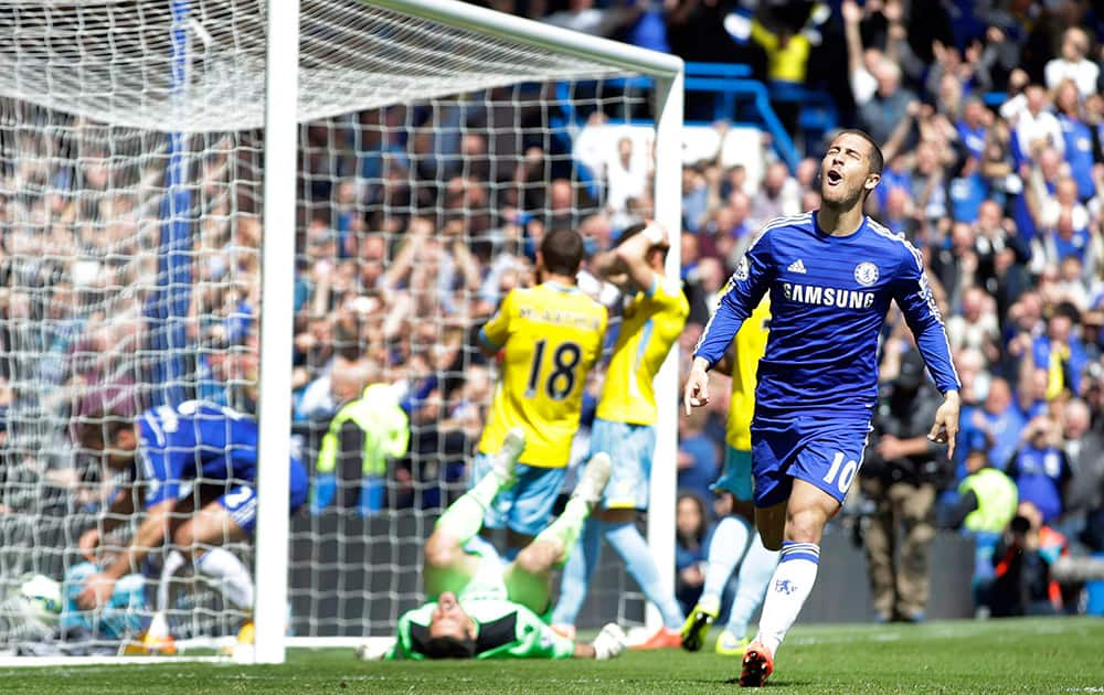 Chelsea's Eden Hazard, right, celebrates after scoring the opening goal during the English Premier League soccer match between Chelsea and Crystal Palace at Stamford Bridge stadium in London.