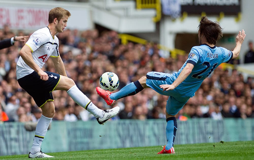 Tottenham Hotspurs's Eric Dier, fights for the ball with Manchester City's David Silva, during the English Premier League soccer match between Tottenham Hotspurs and Manchester City, at White Hart Lane Stadium in London.