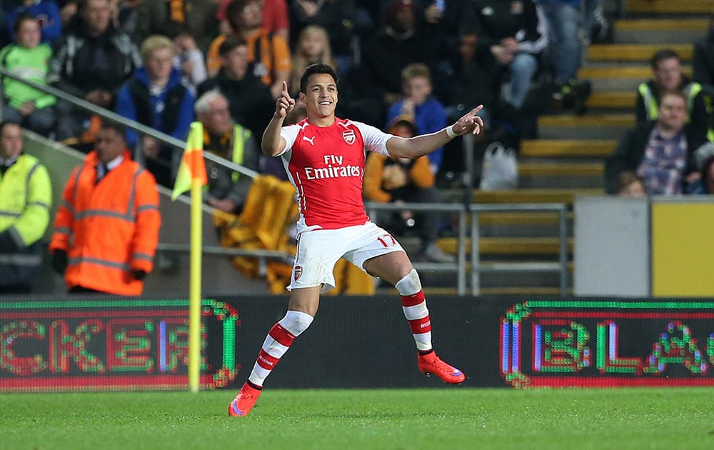 Arsenal's Alexis Sanchez celebrates scoring against Hull City during the English Premier League soccer match at the KC Stadium, Hull, England.