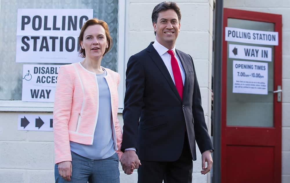 Labour Party leader Ed Miliband and his wife Justine leave the polling station after voting at Sutton Village Hall, Doncaster, England.