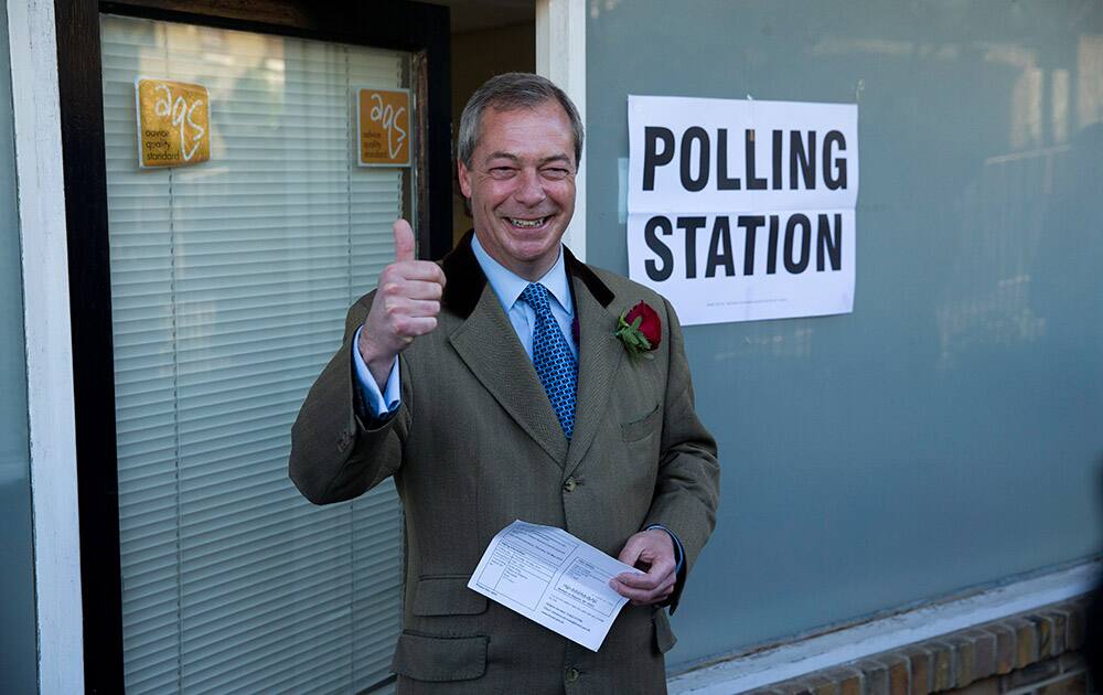 Nigel Farage the leader of the UK Independence Party (UKIP) poses for photographers as he arrives to cast his vote at a polling station in Ramsgate, south east England.