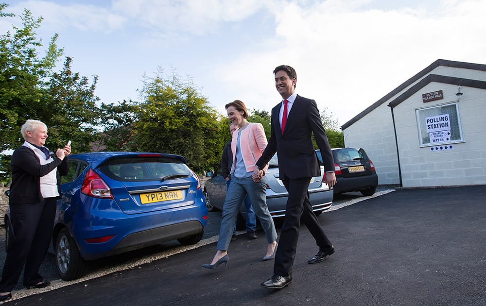 Labour Party leader Ed Miliband and his wife Justine leave the polling station after voting at Sutton Village Hall, Doncaster, England.