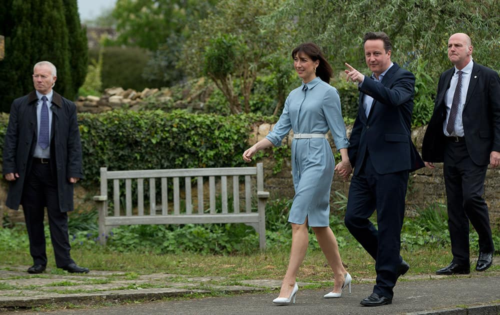 Britain's Prime Minister and Conservative Party leader David Cameron and his wife Samantha arrive to vote at a polling station in Spelsbury, England, as they vote in the general election.