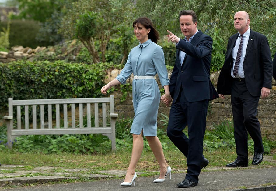 Britain's Prime Minister and Conservative Party leader David Cameron and his wife Samantha arrive to vote at a polling station in Spelsbury, England, as they vote in the general election.