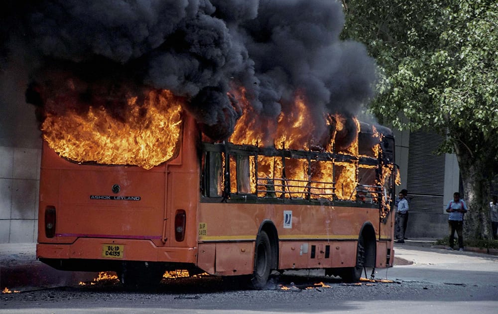 A DTC bus catches fire outside the Shivaji Stadium in New Delhi.