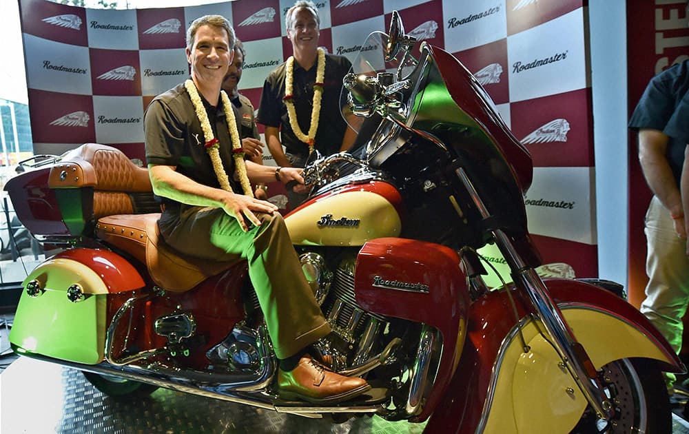 Polaris Industries Inc Chairman & CEO Scott Wine sitting on the bike as President & COO Bennet J Morgan looks on during the launch of the Indian Roadmaster and Indian Chief Dark Horse, luxurious American bike brand in Bengaluru.