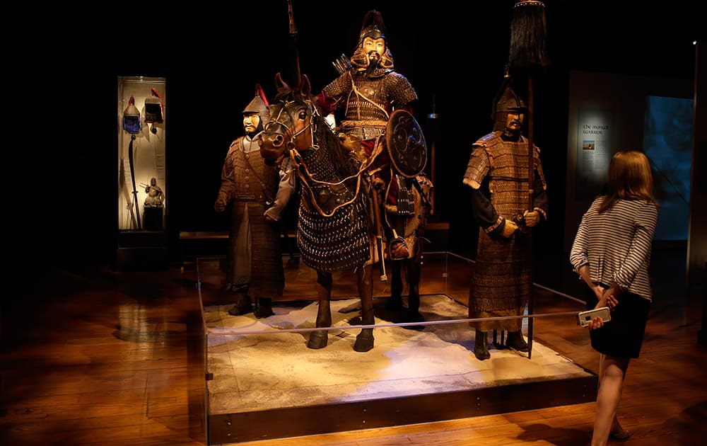 A woman walks through the Genghis Khan: Bring the Legend to Life exhibit during a press preview, at the The Franklin Institute in Philadelphia. 