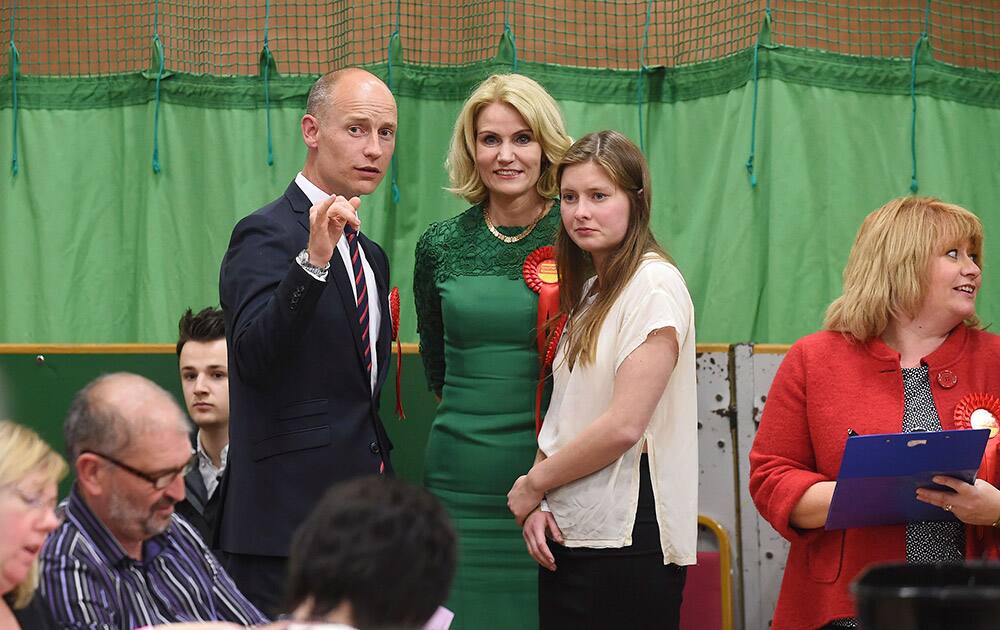 Labour Party Parliamentary candidate for Aberavon Stephen Kinnock, left, with his wife, Prime Minister of Denmark Helle Thorning-Schmidt, center, and daughter Johanna Kinnock, right, stand together during the counting in Britain election at Neath Sports Centre in Neath, Wales.