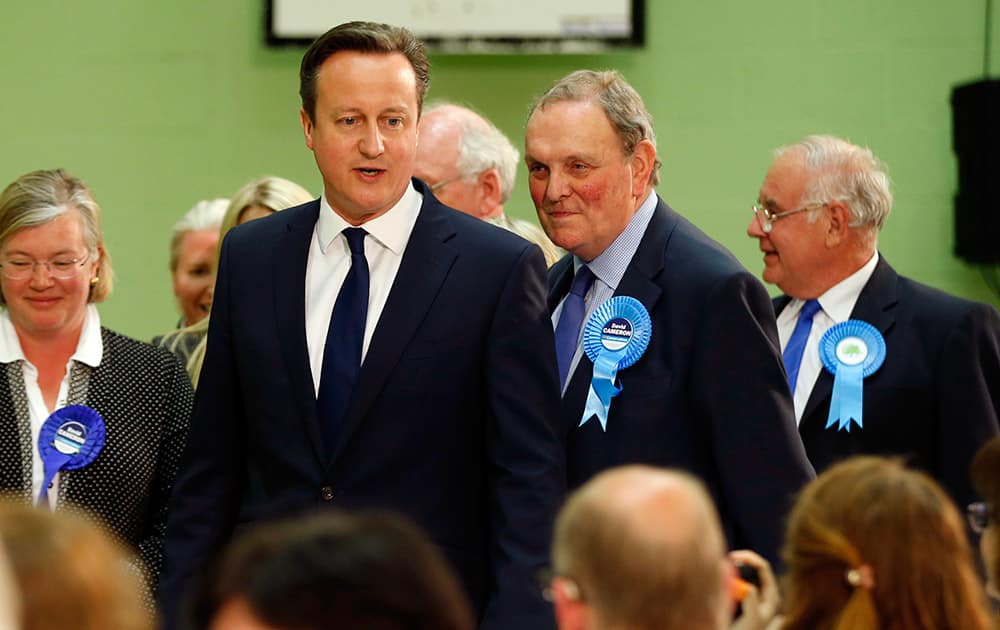 Britain's Conservative party leader David Cameron walks around and talks to party officials and workers at his Witney constituency count in Witney, England.