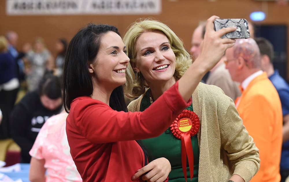 Prime Minister of Denmark Helle Thorning-Schmidt poses for a 'selfie' with a supporter as general election votes are counted at Neath Sports Centre in Neath, Wales, where her husband Stephen Kinnock is standing for Labour in the Aberavon seat.