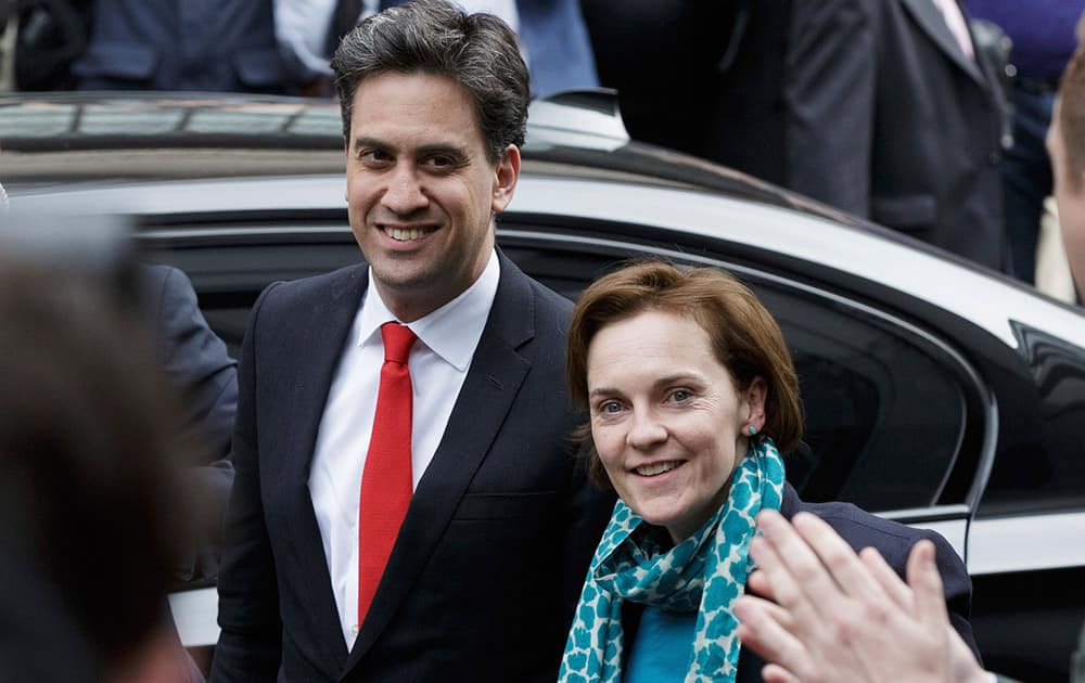 Labour Party leader Ed Miliband arrives with his wife Justine at Labour Party headquarters in Westminster, London.