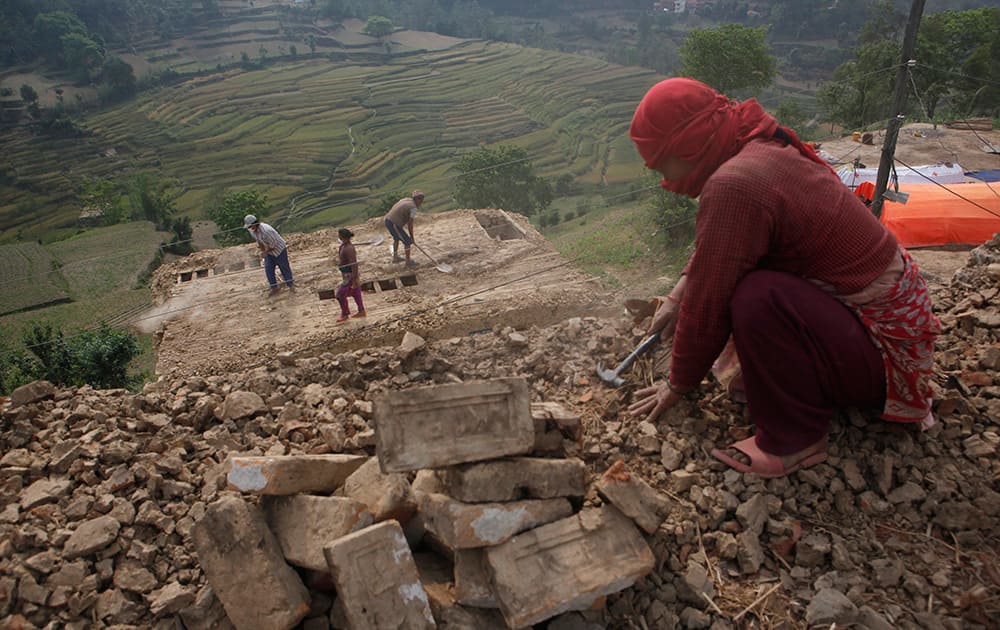 Nepalese people work to rebuild their damaged homes in Lalitpur, Nepal.