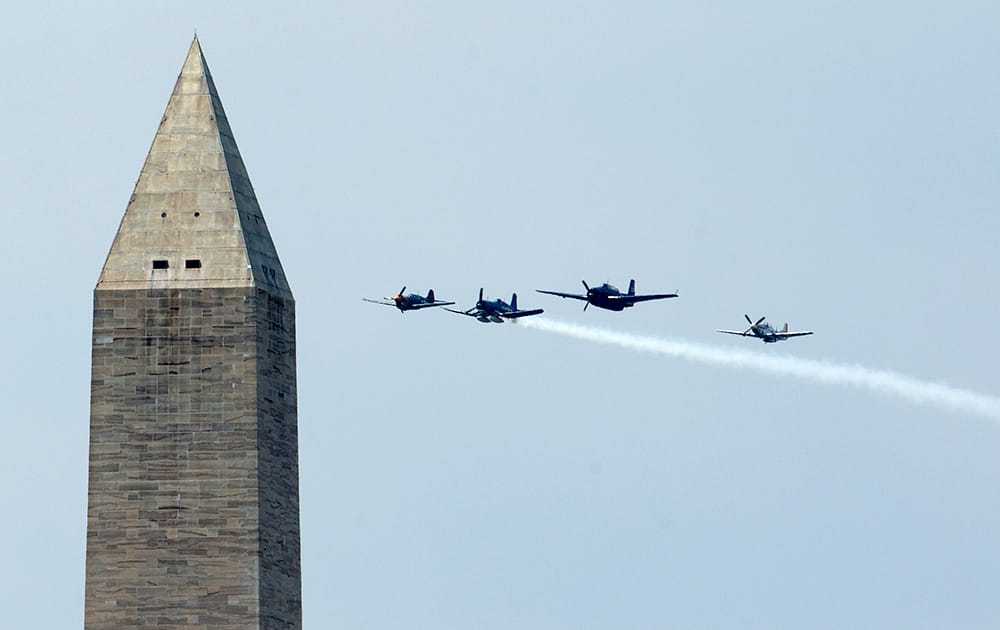 World War II vintage aircrafts fly the Missing Man formation during a flyover near the Washington Monument in Washington.