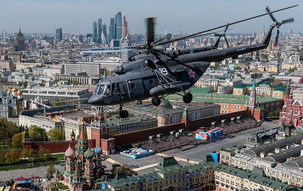 A Russian airforce Mi-8 helicopter flies over the Moskva River, with the Kremlin in the background during a rehearsal of a V-Day military parade in Moscow, Russia.