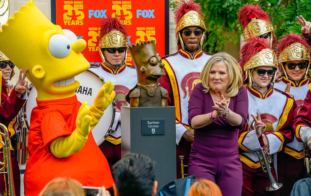 The voice of Bart Simpson Nancy Cartwright celebrates celebrate the unveiling of the Bart Simpson Bartman sculpture along with the Trojan Marching Band.