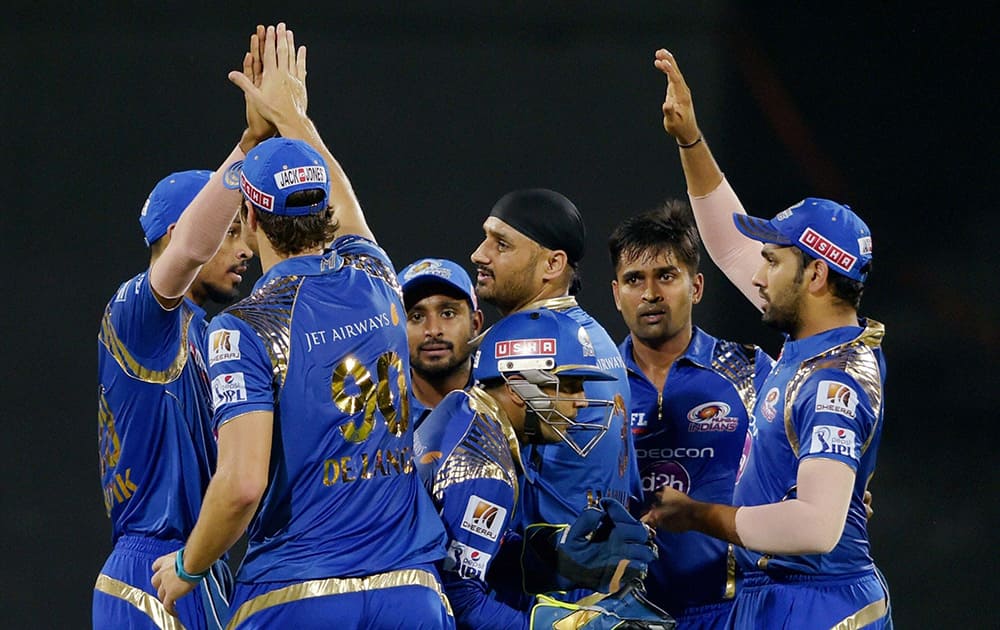 Mumbai Indian’ Vinay Kumar celebrates along with teammates after dismissing a Chennai Super Kings Brendon McCullum during their IPL-2015 at MAC Stadium in Chennai.