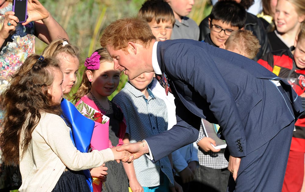 Britain's Prince Harry meets children from Kilbirnie School during a welcome ceremony at Government House in Wellington, New Zealand.