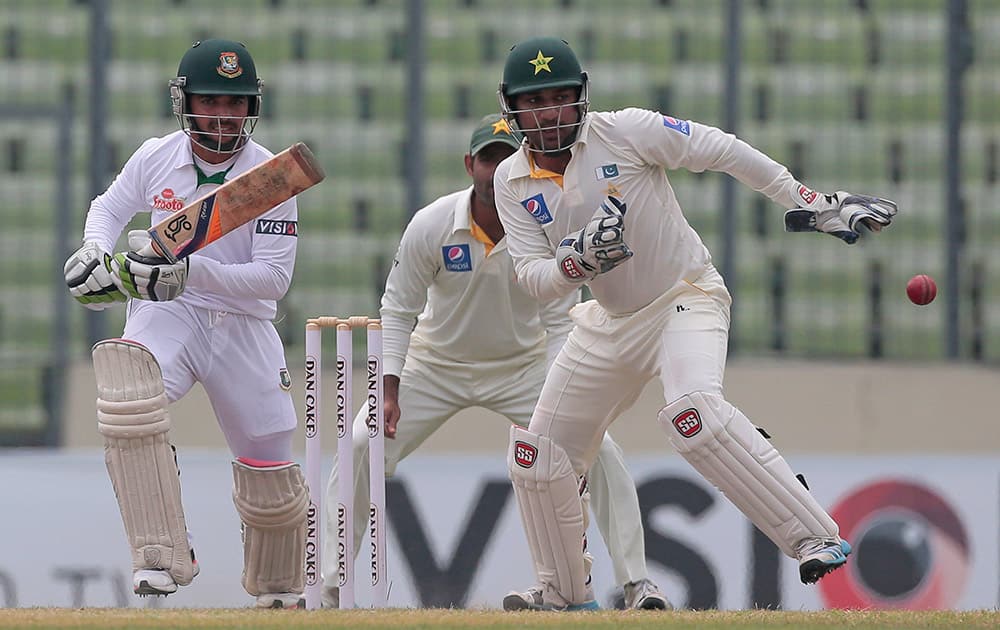 Bangladesh’s Mominul Haque plays a shot, as Pakistan's wicketkeeper Sarfraz Ahmed follows the ball during the fourth day of their second test cricket match in Dhaka, Bangladesh.