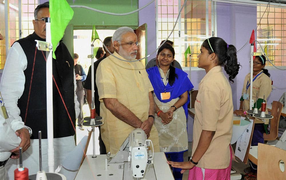 Prime Minister Narendra Modi interacts with students at Livelihood College in Dantewada in Chhattisgarh. Chhattisgarh CM Raman Singh is also seen.