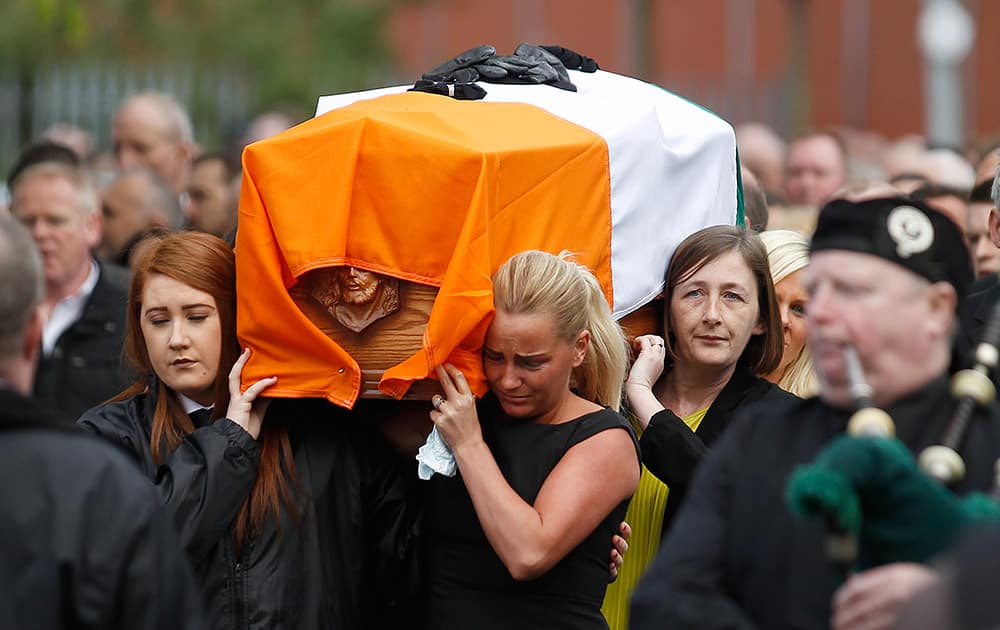 Friends and family carry the coffin of former IRA leader Gerard Davison through the Markets area of South Belfast, Northern Ireland. The senior Republican was gunned down outside his home Tuesday.