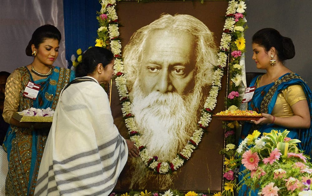 West Bengal Chief Minister Mamata Banerjee pays homage to Nobel laureate poet Rabindra Nath Tagore on his 154th birth anniversary at Rabindra Sadan, Kolkata.