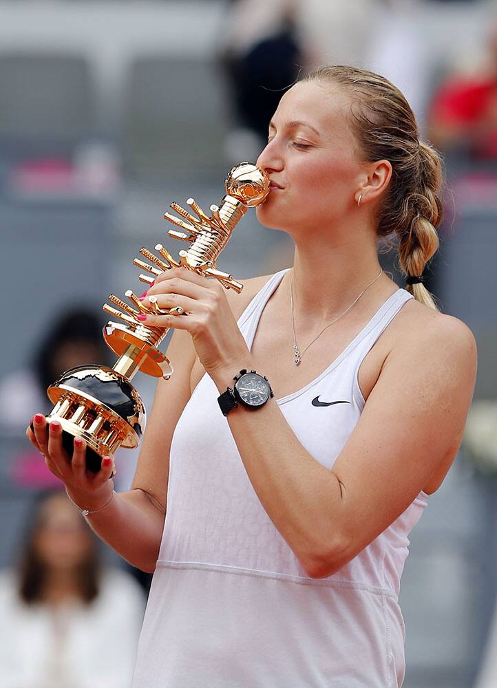Petra Kvitova of the Czech Republic kisses the trophy after defeating Svetlana Kuznetsova of Russia in their women's singles final match at the Madrid Open Tennis tournament.