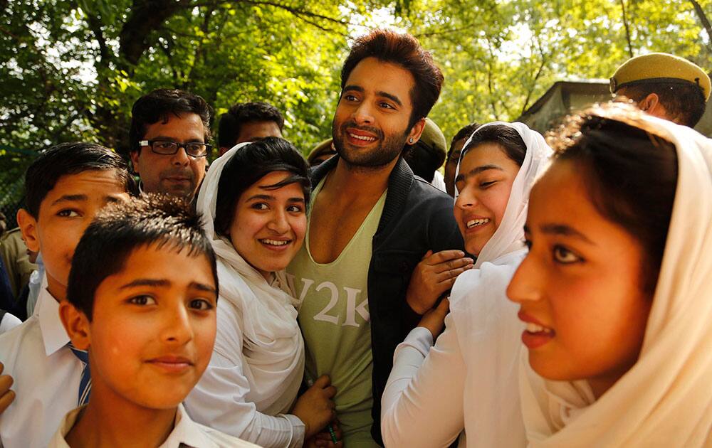 Bollywood actor Jackky Bhagnani poses for photographs with Kashmiri students at a promotional event of his upcoming film 