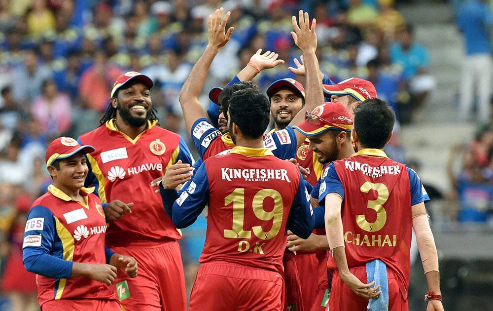 Royal Challengers Bangalore players celebrate a wicket of Mumbai Indians batsman Rohit Sharma during an IPL T20 match played in Mumbai.